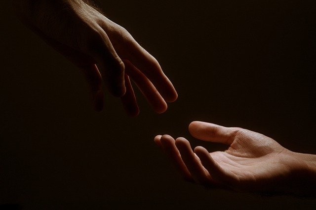 Hands reaching each other